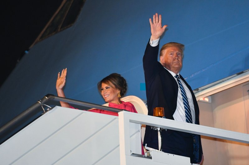 U.S. President Donald Trump and First Lady Melania Trump wave as they board Air Force One at Palam Air Force Airport in New Delhi on Feb. 25, 2020. (AFP Photo)