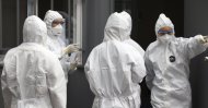 Officials wearing protective attire work to diagnose people with suspected symptoms of the new coronavirus at a hospital in Daegu, South Korea, Feb. 26, 2020. (Yonhap via AP)