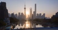 This aerial picture shows the sun rising behind the skyline of Shanghai's Lujiazui financial district of Pudong, Nov. 13, 2018. (AFP File Photo)