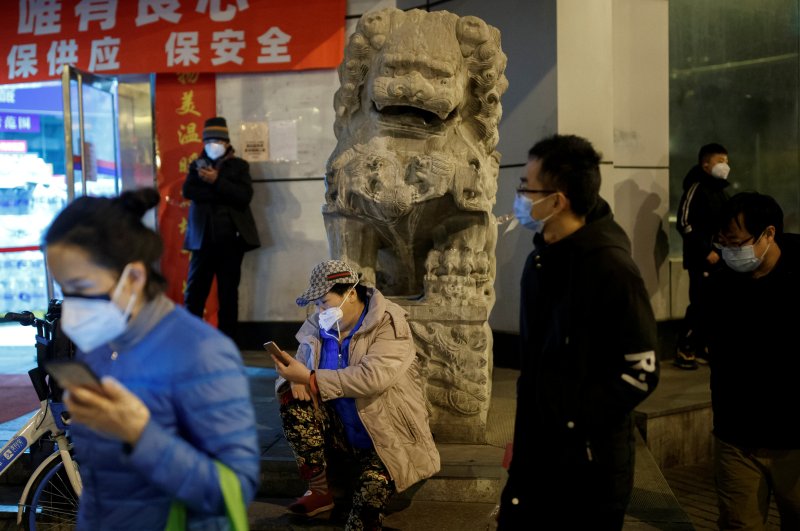 People wear face masks in a street in Beijing, China, Feb. 26, 2020. (Reuters Photo)