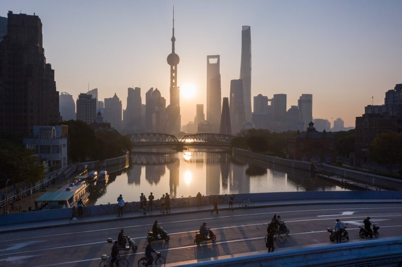 This aerial picture shows the sun rising behind the skyline of Shanghai's Lujiazui financial district of Pudong, Nov. 13, 2018. (AFP File Photo)