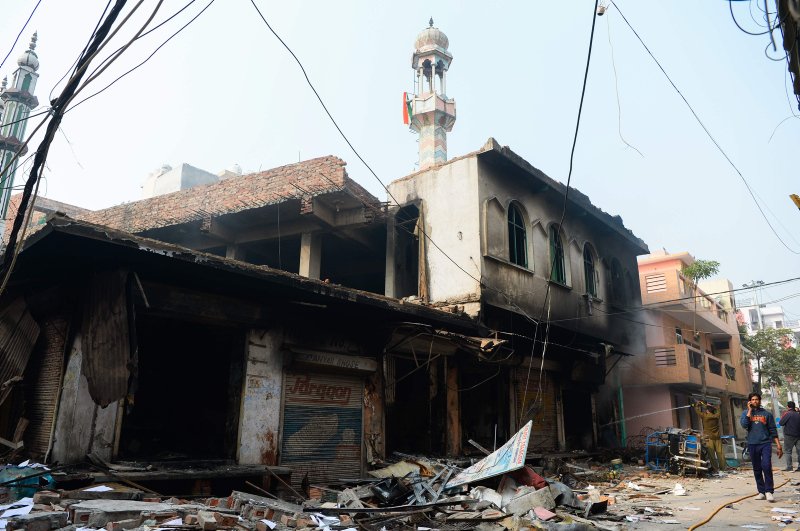 The photo shows a burnt-out mosque and shops following clashes, New Delhi, Feb. 26, 2020. (AFP Photo)