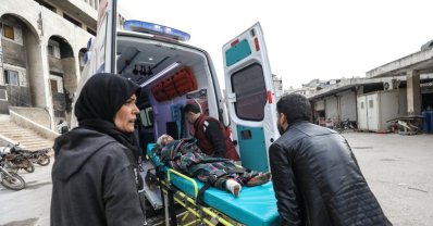 A child is taken into an ambulance after an Assad regime bombardment (AA Photo)