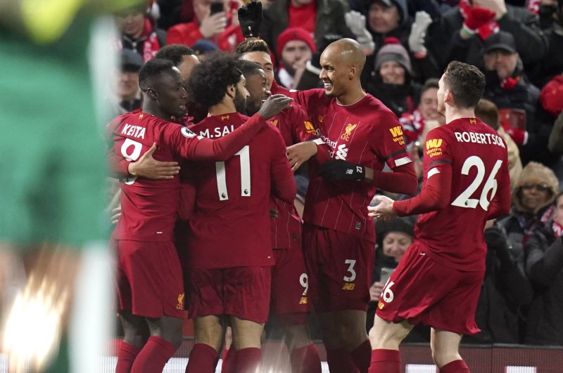 Liverpool players celebrate a first goal during an EPL match against, Feb. 24, 2020. (AP Photo)