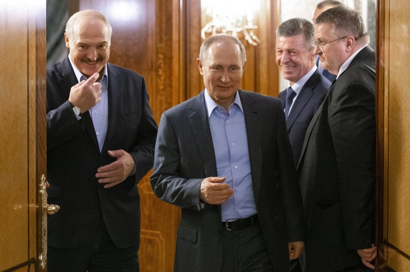 In this file photo taken on Friday, Feb. 7, 2020, Russian President Vladimir Putin, center, and Belarusian President Alexander Lukashenko enter a hall for talks in Rosa Khutor, in the Black Sea resort of Sochi, Russia. (AP Photo)