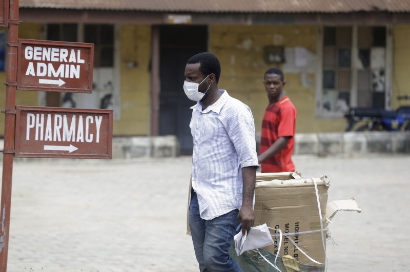 A man wearing a face mask walks at the Mainland Hospital Yaba, where the first Nigerian victims are being treated, Lagos, Feb. 28, 2020. (AP Photo)