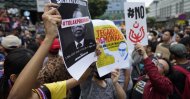 Demonstrators hold placards during a protest against Malaysia's newly sworn-in prime minister, Muhyiddin Yassin, Kuala Lumpur, March 1, 2020. (AP Photo)