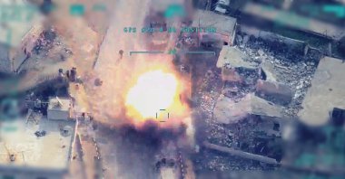 The footage shows a Turkish drone hitting Assad regime elements in the northern Syrian town of Idlib. (AA Photo)

