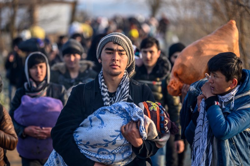 Migrants walk towards the Greek border in Pazarkule, in the Edirne district, March 1, 2020. (AFP)