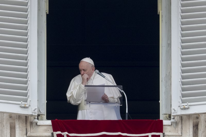 Pope Francis coughs during the Angelus noon prayer from the window of his studio overlooking St. Peter's Square, at the Vatican, March 1, 2020. (AP Photo)