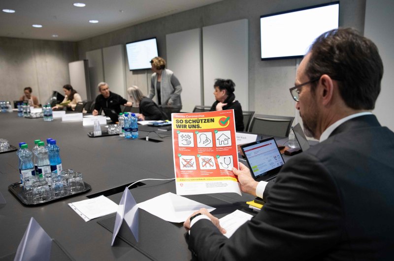 Pascal Strupler, director of the Federal Office of Public Health, holds a flyer prior to a meeting of the task force of the Federal Office of Public Health on the prevention of the further spread of COVID-19, Bern, Feb. 28, 2020. (AFP Photo)