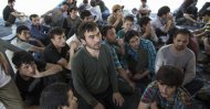 Suspected Uighurs from China's troubled far-western region of Xinjiang, sit inside a temporary shelter after they were detained at the immigration regional headquarters near the Thailand-Malaysia border in Hat Yai, Songkla March 14, 2014. (Reuters File Photo)