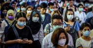 Commuters wearing facemasks wait for a canal boat, Bangkok, March 2, 2020. (AFP Photo)