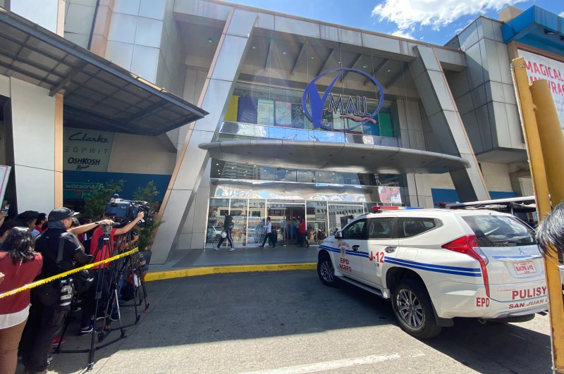 Journalists gather outside the V-Mall where gunshots rang out inside in Manila, March 2, 2020. (AP)