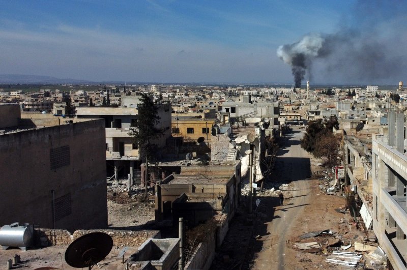 Smoke billows over the town of Saraqib in the eastern part of the Idlib province in northwestern Syria, following bombardment by Assad regime forces, Feb. 27, 2020. (AFP Photo)