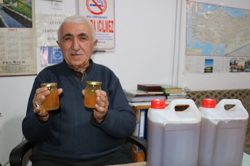 Mehmet Kasım Alageyik poses with jars of what he claims contain the solution to the world's coronavirus problem, Van, March 2, 2020. (İHA Photo)