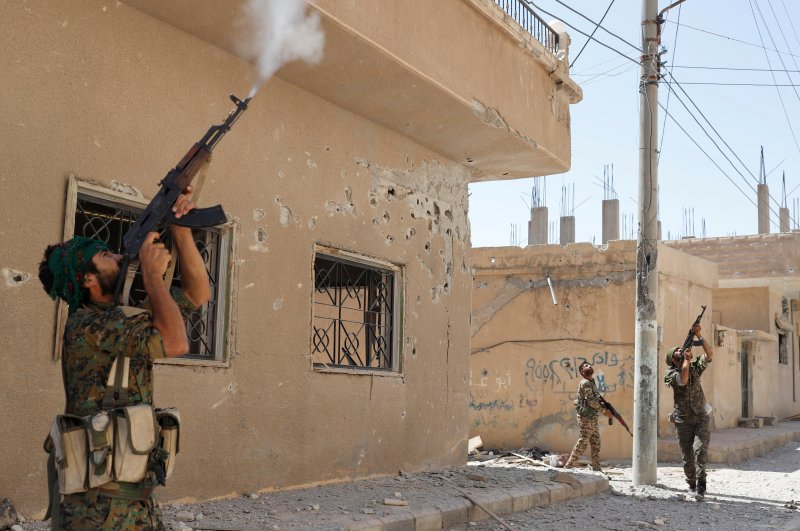  The YPG terrorists fire rifles at a drone in Raqqa, June 16, 2018. (REUTERS)
