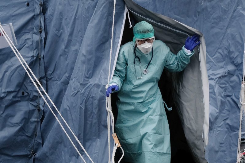 A nurse wears an overall and a mask at the medical checkpoint at the entrance of "Spedali Civili" hospital, Brescia, Italy, March 2, 2020. (EPA Photo)