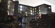 Debris is scattered across the parking lot of a damaged apartment building after a tornado hit Nashville in the early morning hours of Tuesday, March 3, 2020. (Courtney Pedroza/The Tennessean via AP)