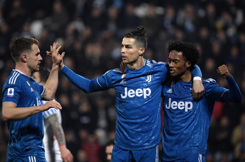 Juventus players Cristiano Ronaldo (C), Cuadrado (R) and Aaron Ramsey celebrate their team's goal against SPAL, Feb. 22, 2020. (AFP Photo)