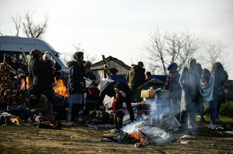 Migrants gather in a field at Maritsa river (Evros river in Greek) near Edirne, at the Turkish-Greek border, March 3, 2020.  (AP Photo)