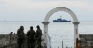 Military personnel watch on a pier as navy ship sails near the crash site of a Russian military Tu-154 plane, which crashed into the Black Sea on its way to Syria on Sunday, in the Black Sea resort city of Sochi, Russia, Dec. 26, 2016. (Reuters File Photo)