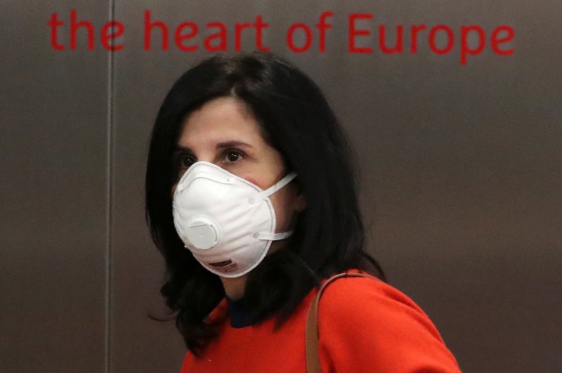 A woman wearing a protective face mask is seen at Brussels Airport, March 4, 2020. (REUTERS Photo)