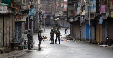 Indian paramilitary soldiers stand guard on a deserted street during curfew in Srinagar, Aug. 8, 2019. (AP Photo)
