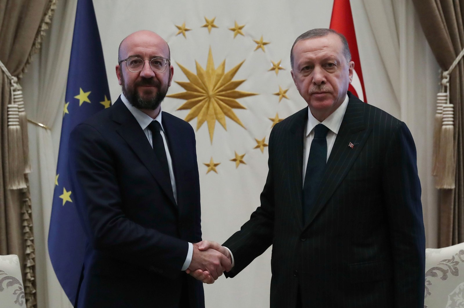 President Recep Tayyip Erdoğan (R) shaking hands with European Council’s President Charles Michel (L) at the Presidential Complex in Ankara, on March 4, 2020. (AFP Photo)