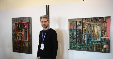 Hamdi Çınar poses in front of his artwork. (AA Photo)