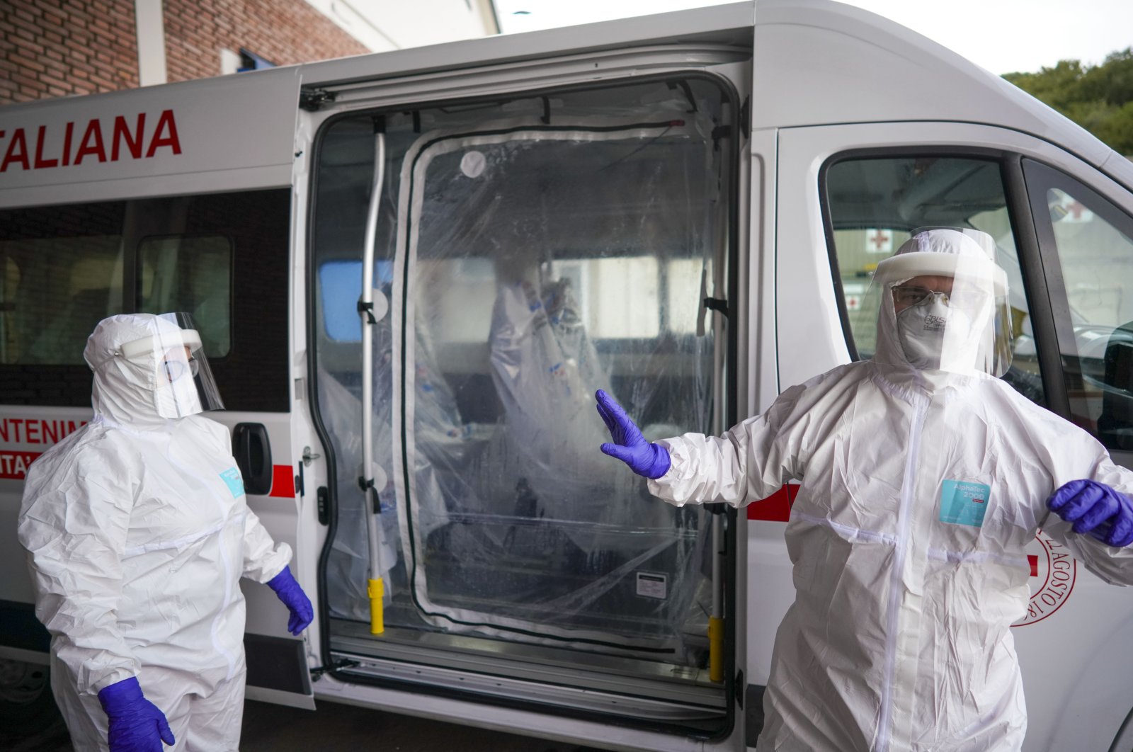 Red Cross personnel prepare for the transport of a Coronavirus patient during a simulation, in Rome, Friday, March 6, 2020. (AP Photo)