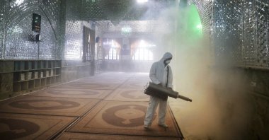 A firefighter disinfects the shrine of Saint Saleh to help prevent the spread of the new coronavirus in northern Tehran, Iran, Friday, March, 6, 2020. (AP Photo)