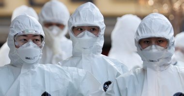Medical workers in protective gears walk into a hospital facility to treat coronavirus patients amid the rise in confirmed cases in Daegu, South Korea, March 8, 2020. (Reuters Photo)