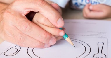 Your children should start to transition to the "tripod grip" from a five-finger grip around age 3 or 4. (iStock Photo)