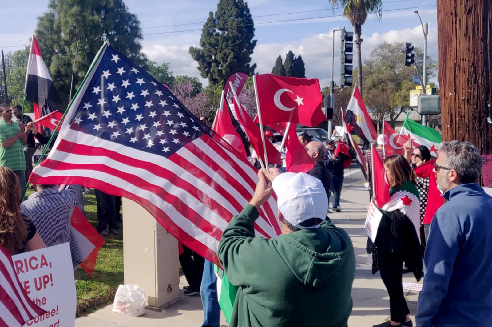 Demonstrators carrying Turkish, American and Syrian flags in their hands gathered in Los Angeles' Anaheim city in solidarity with Turkish soldiers in Idlib, March 9, 2020. (IHA PHOTO)