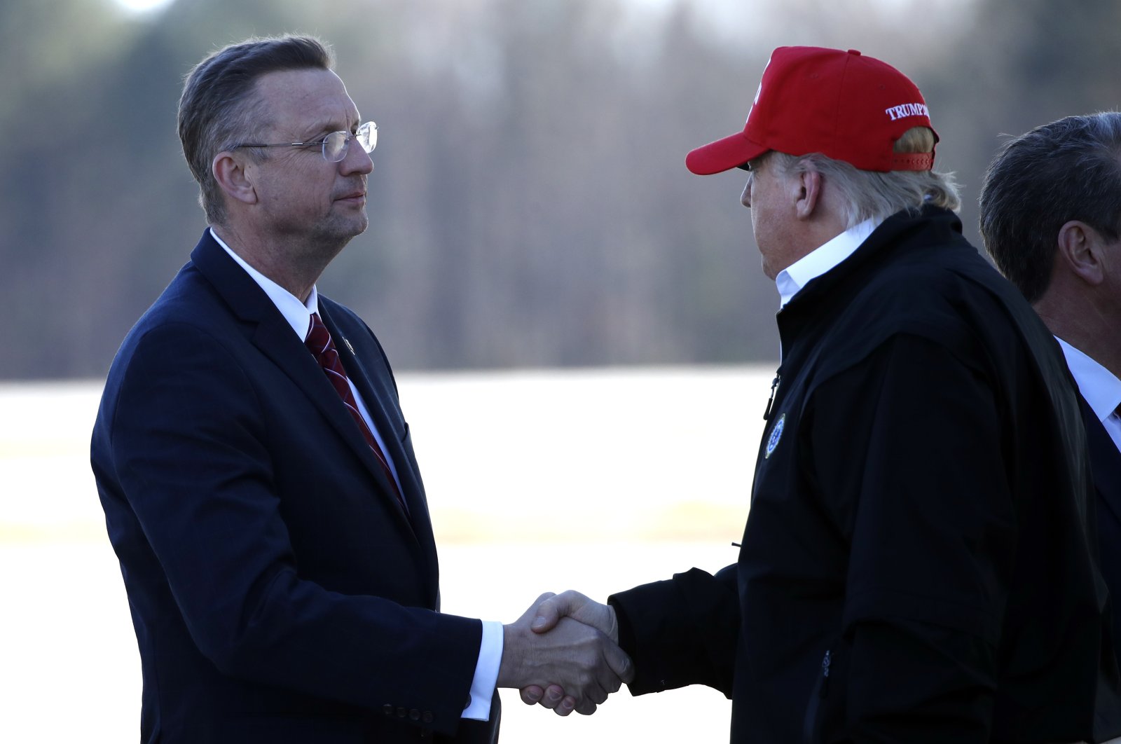 President Donald Trump greets Rep. Doug Collins, R-Ga., as he arrives on Air Force One Friday, March 6, 2020, at Dobbins Air Reserve Base in Marietta, Ga. (AP Photo)