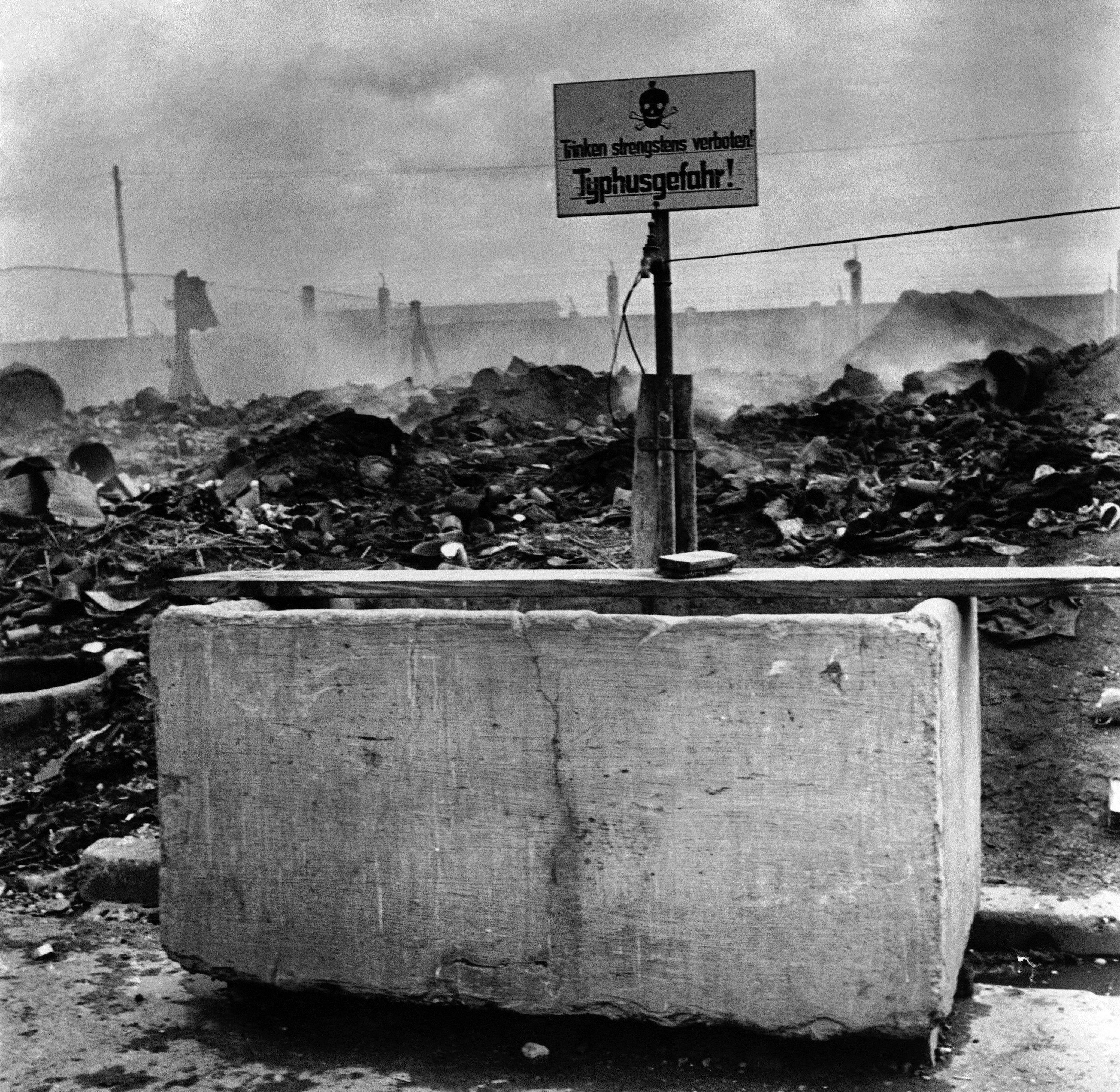 This undated photo shows a fountain marked 'Don't Drink Danger, Typhus' is seen among the ruins of Dachau Concentration Camp, near Munich, Germany. (AP Photo)