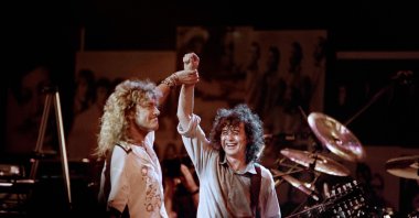 In this file photo, British singer Robert Plant (L) holds hands raised high with British guitarist Jimmy Page during a Led Zeppelin reunion performance at Madison Square Garden in New York, May 14, 1988. (AFP Photo)