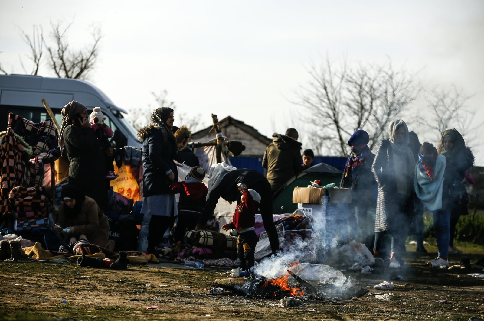 Migrants gather in a field at the Maritsa river near Edirne, at the Turkish-Greek border, March 3, 2020. (AP Photo)