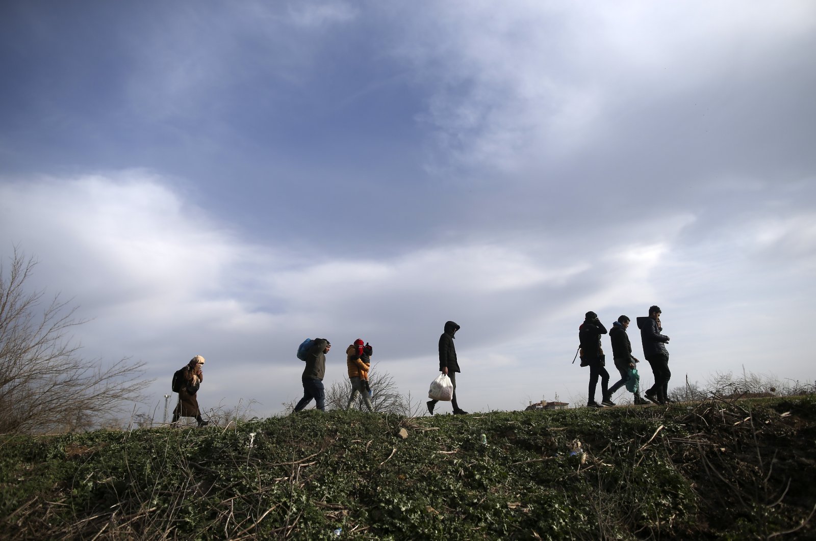 Migrants walk in Edirne at the Turkish-Greek border, March 9, 2020. (AP Photo)