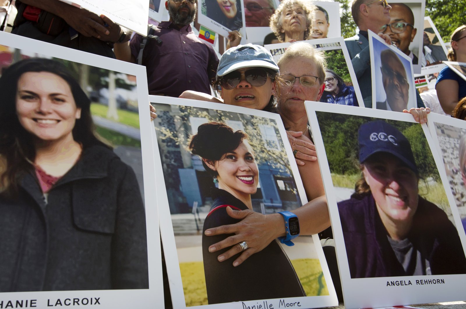 Mothers Clariss Moore (L) and Joana Vincent hold the pictures of their daughters during a vigil on the six-month anniversary of the crash of a Boeing 737 Max 8, Washington, D.C., Sept. 10, 2019. (AP Photo)