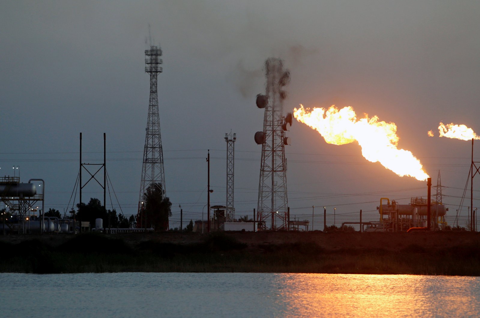 Flames emerge from flare stacks at Nahr Bin Umar oil field, north of Basra, Iraq, March 9, 2020. (Reuters Photo)