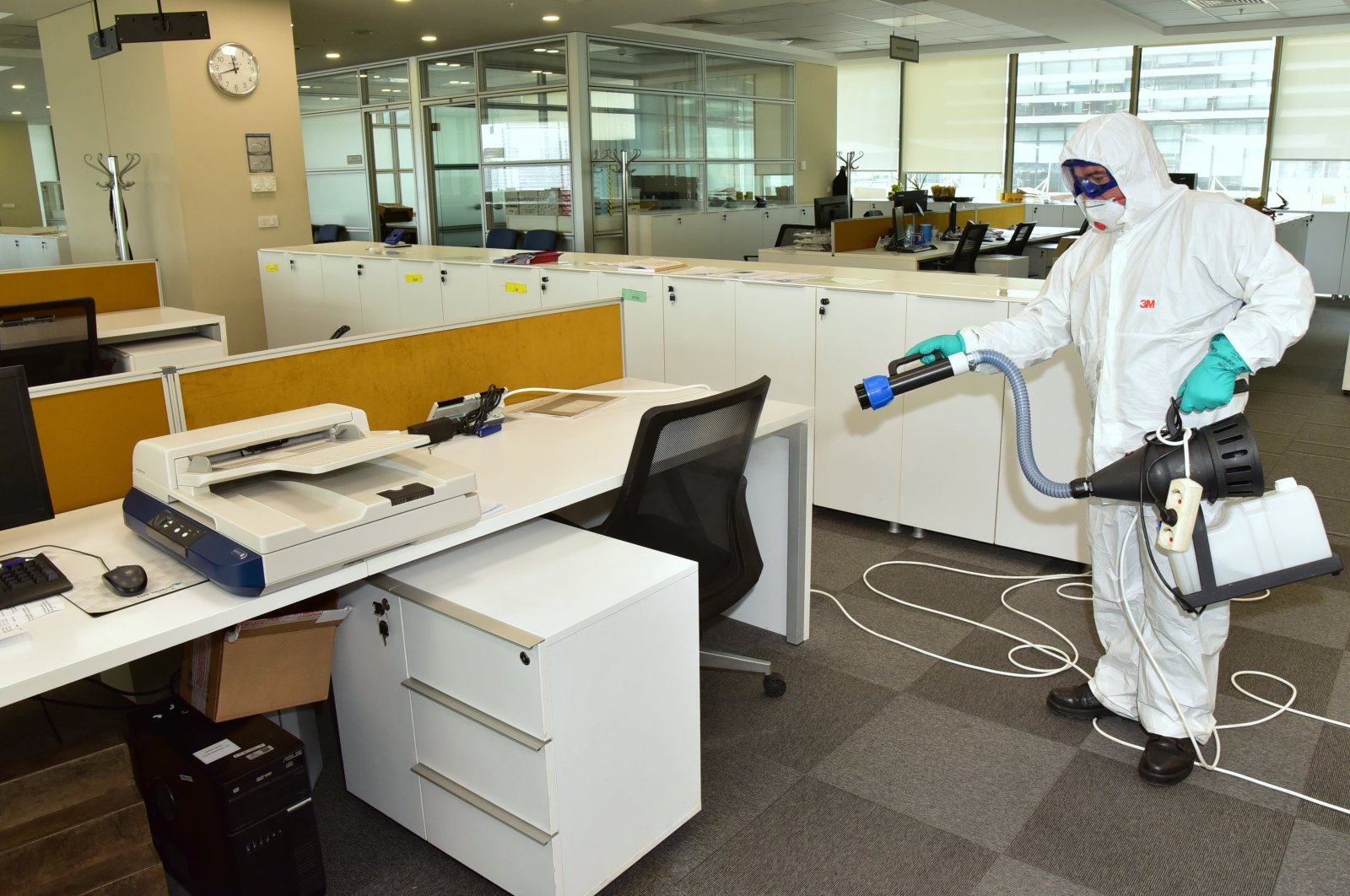 A man seen with a disinfection equippment in an office in Turkey. (IHA Photo)