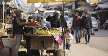 People shop in the city of Idlib, Syria, March 9, 2020, during the truce brokered by Turkey and Russia. (AP Photo)