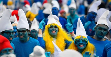 People dressed as Smurfs, a Belgian comic franchise centered on a fictional colony of small, blue, human-like creatures who live in mushroom-shaped houses in the forest, attend a world-record gathering of Smurfs on March 7, 2020, in Landerneau, western France. (AFP Photo)