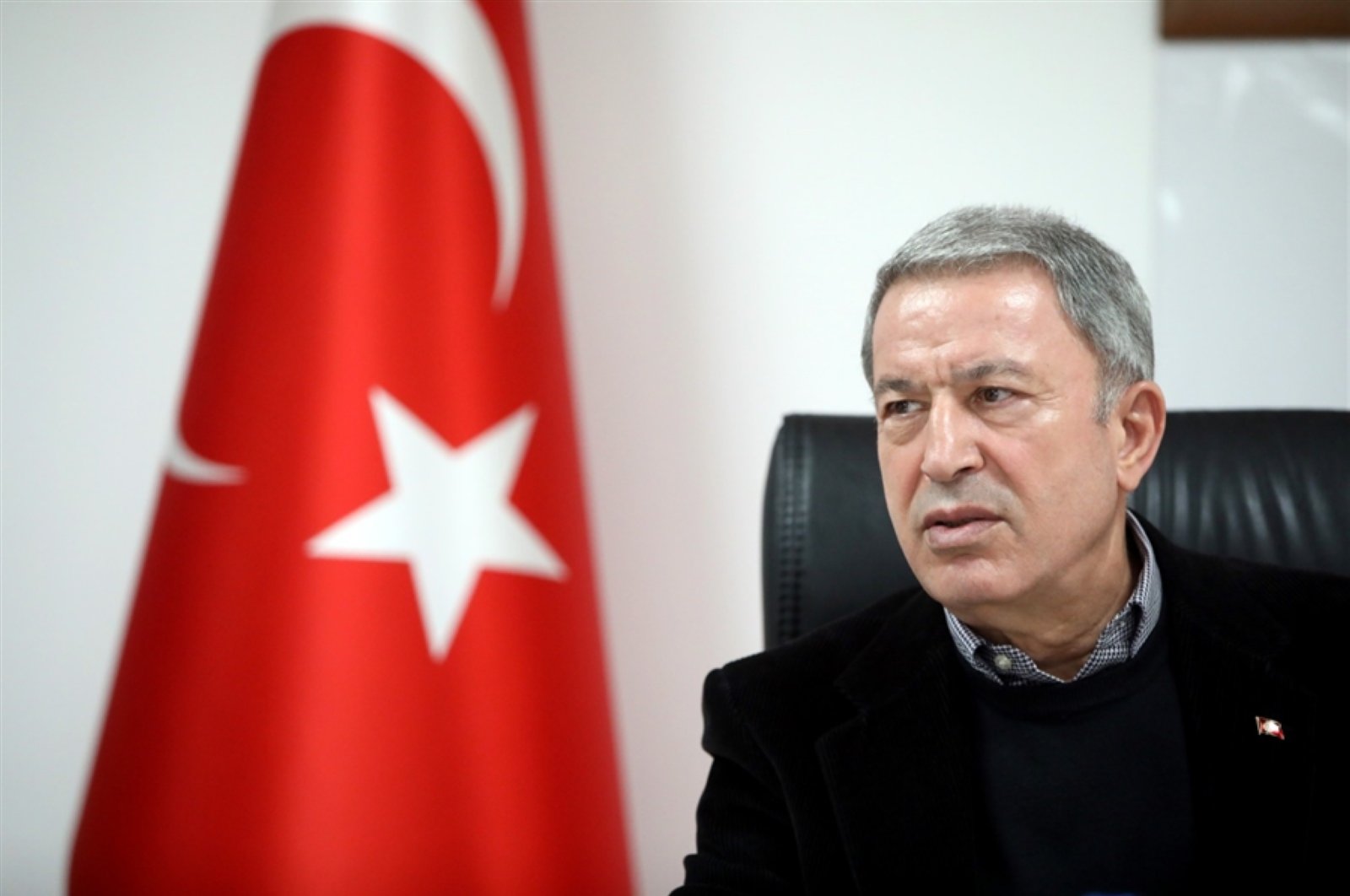 Defense Minister Hulusi Akar speaks at the Turkey-Syria border on the Syrian crisis, March 7, 2020. (DHA Photo)