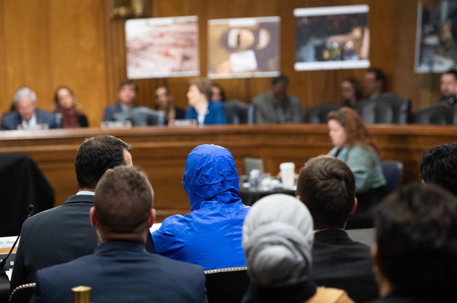 A Syrian military defector using the pseudonym Caesar, while also wearing a hood to protect his identity, testifies about the war in Syria during a Senate Foreign Relations committee hearing on Capitol Hill in Washington, DC, March 11. (AFP Photo)