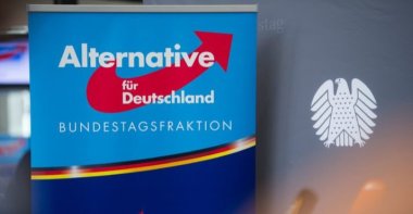 A poster with the AfD logo is pictured next to a Bundestag background banner, Berlin, Sept. 26, 2017. (AFP Photo)