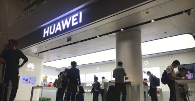 In this Nov. 15, 2019, file photo, people look at a Huawei store in Shenzhen Bao'an International Airport in Shenzhen in southern China's Guangdong Province. (AP File Photo)