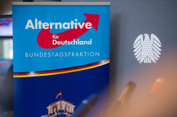 A poster with the AfD logo is pictured next to a Bundestag background banner, Berlin, Sept. 26, 2017. (AFP Photo)